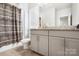 Bathroom with grey cabinets, granite countertop, and neutral-toned shower curtain at 432 Belton St, Charlotte, NC 28209