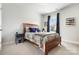 Bright bedroom features neutral walls and a wood bed frame with playful sports themed bedding at 432 Belton St, Charlotte, NC 28209