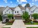Attractive townhome exterior featuring a two-car garage, stone accents, and manicured landscaping at 432 Belton St, Charlotte, NC 28209