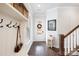 Inviting foyer with dark wood floors, a coat rack, and a glass-paneled front door at 432 Belton St, Charlotte, NC 28209