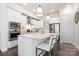 Modern kitchen featuring white cabinets, a center island with seating, and sleek stainless steel appliances at 432 Belton St, Charlotte, NC 28209