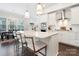 Stylish kitchen with stainless steel appliances, a white island with seating, and modern pendant lighting at 432 Belton St, Charlotte, NC 28209