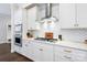 Bright kitchen with white cabinetry, stainless steel appliances, and herringbone backsplash detail at 432 Belton St, Charlotte, NC 28209