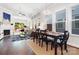 Open-concept living and dining area with fireplace, large windows, and hardwood floors at 432 Belton St, Charlotte, NC 28209
