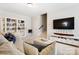Open living room features built-in shelving, neutral decor, plush seating, and lots of light at 432 Belton St, Charlotte, NC 28209