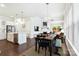Open concept dining and living space with hardwood floors, fireplace, and access to the outdoor deck at 432 Belton St, Charlotte, NC 28209