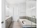Luxurious primary bathroom with dual vanities, soaking tub, and glass-enclosed shower at 432 Belton St, Charlotte, NC 28209