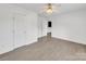 A white bedroom features a ceiling fan and light gray laminate flooring at 4328 Camden Rd, Marshville, NC 28103