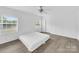 Bright bedroom featuring hardwood flooring, a ceiling fan, large windows, and white walls at 4328 Camden Rd, Marshville, NC 28103