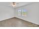 Bedroom features a ceiling fan, blinds on the windows, and vinyl flooring at 4328 Camden Rd, Marshville, NC 28103