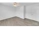 Bright bedroom with gray wood-look flooring, a ceiling fan, and a closet door at 4328 Camden Rd, Marshville, NC 28103