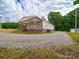 View of the home with a covered porch and gravel driveway at 4328 Camden Rd, Marshville, NC 28103