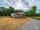 Home exterior with covered porch, set on a spacious lot with gravel driveway at 4328 Camden Rd, Marshville, NC 28103
