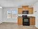 Kitchen and dining area with a window and black appliances at 4328 Camden Rd, Marshville, NC 28103