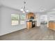 An open kitchen and dining area with hardwood floors and wooden cabinets at 4328 Camden Rd, Marshville, NC 28103