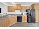 Functional kitchen featuring wood cabinets, modern appliances, and durable countertops and flooring at 4328 Camden Rd, Marshville, NC 28103