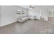 Bright living room featuring a ceiling fan, large windows and hardwood flooring at 4328 Camden Rd, Marshville, NC 28103