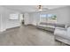 Bright living room featuring a ceiling fan, large windows and hardwood flooring at 4328 Camden Rd, Marshville, NC 28103