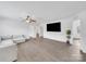 Bright and spacious living room featuring hardwood flooring, a ceiling fan, and white walls at 4328 Camden Rd, Marshville, NC 28103