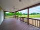 Large covered porch overlooking a vast green field, perfect for relaxing at 4328 Camden Rd, Marshville, NC 28103