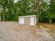 An outdoor shed with a gravel foundation and surrounded by trees at 4328 Camden Rd, Marshville, NC 28103