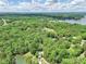 Picturesque aerial view of the property nestled among lush trees and near a serene lake in a beautiful landscape at 4585 Sunrise Beach Rd, Catawba, NC 28609