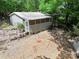 View of home featuring an enclosed back porch with white lattice and stairs leading to yard surrounded by trees at 4585 Sunrise Beach Rd, Catawba, NC 28609