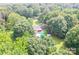 Aerial shot of home with above ground pool and backyard outbuildings, nestled in trees at 4805 Nesbitt Rd, Monroe, NC 28112