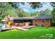 Beautifully landscaped backyard features large wooden deck and in-ground swimming pool at 4805 Nesbitt Rd, Monroe, NC 28112