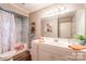 Neutral bathroom with an updated vanity, shower with curtain, and natural light at 4805 Nesbitt Rd, Monroe, NC 28112