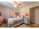 Comfortable bedroom with hardwood flooring, decorated with hanging wall decor and plants at 4805 Nesbitt Rd, Monroe, NC 28112