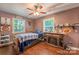Rustic bedroom with a wood-look floor, a faux fireplace, and comfortable furnishings at 4805 Nesbitt Rd, Monroe, NC 28112
