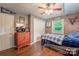 Bedroom with wood floors, closet, dresser, and sports decor, creating a fun vibe at 4805 Nesbitt Rd, Monroe, NC 28112