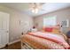 Well lit bedroom with a full size bed, hardwood floors, and a white trim door at 4805 Nesbitt Rd, Monroe, NC 28112