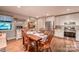 Inviting dining area with wooden table, stainless steel appliances, and bright white cabinetry at 4805 Nesbitt Rd, Monroe, NC 28112