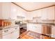 Well-lit kitchen with white cabinets, stainless steel appliances, granite counters, and a beautiful, decorative rug at 4805 Nesbitt Rd, Monroe, NC 28112