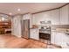 Open kitchen featuring white cabinets, stainless steel appliances and a view into an inviting living room at 4805 Nesbitt Rd, Monroe, NC 28112