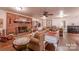 Spacious living room featuring hardwood floors, a brick fireplace, and comfortable seating arrangement at 4805 Nesbitt Rd, Monroe, NC 28112