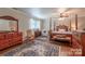 Spacious main bedroom featuring a four poster bed, hardwood floors, and ample natural light at 4805 Nesbitt Rd, Monroe, NC 28112