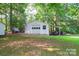 Outbuilding in backyard setting featuring a garage door and covered porch at 4805 Nesbitt Rd, Monroe, NC 28112