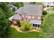 Aerial view of a two-story brick home with a well-manicured lawn, mature trees, and a screened-in porch at 5827 Rileys Ridge Rd, Charlotte, NC 28226