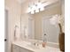Bathroom with a white vanity, a large mirror, and a decorative vase with flowers at 5827 Rileys Ridge Rd, Charlotte, NC 28226