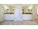 Bathroom with double sinks, white cabinets, granite countertop, and large mirrors giving a spacious feel at 5827 Rileys Ridge Rd, Charlotte, NC 28226