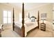 Comfortable bedroom featuring a four-poster bed, soft lighting, and windows offering a serene retreat at 5827 Rileys Ridge Rd, Charlotte, NC 28226