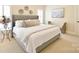 Bedroom with a tufted headboard bed, plush bedding, and bright natural light at 5827 Rileys Ridge Rd, Charlotte, NC 28226