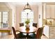 Inviting breakfast nook has a window with views of the landscaped backyard and a stylish light fixture at 5827 Rileys Ridge Rd, Charlotte, NC 28226