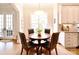 Cozy breakfast nook featuring a round table with seating, large windows, and views to the kitchen at 5827 Rileys Ridge Rd, Charlotte, NC 28226