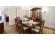 Formal dining room featuring a wooden table and chairs, ornate china cabinet, and chandelier lighting at 5827 Rileys Ridge Rd, Charlotte, NC 28226