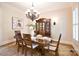 Refined dining room features classic wainscoting, chandelier lighting and sophisticated furnishings at 5827 Rileys Ridge Rd, Charlotte, NC 28226