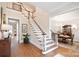 Spacious foyer featuring hardwood floors, elegant staircase, and seamless flow to dining area at 5827 Rileys Ridge Rd, Charlotte, NC 28226